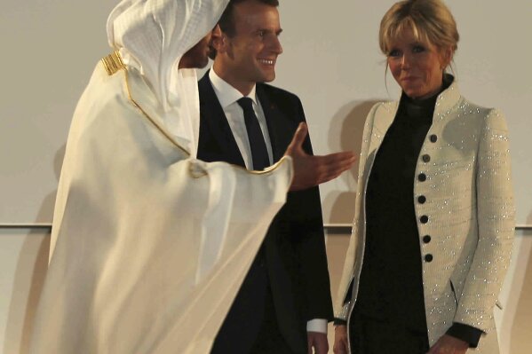 
              French President Emmanuel Macron, second left, and his wife, Brigitte, are welcomed by Abu Dhabi Crown Prince Mohammed bin Zayed al-Nahayan to the official opening of Louvre Abu Dhabi museum, Wednesday, Nov. 8, 2017, in Abu Dhabi, United Arab Emirates. (AP Photo/Kamran Jebreili)
            