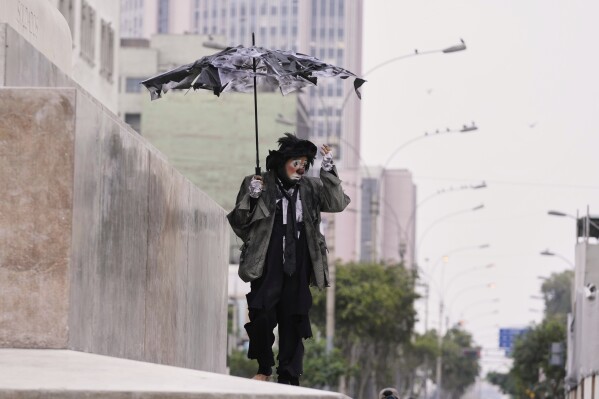 A clown walks to take part in National Clown Day celebrations in Lima, Peru, Sunday, May 25, 2025. (AP Photo/Martin Mejia)
