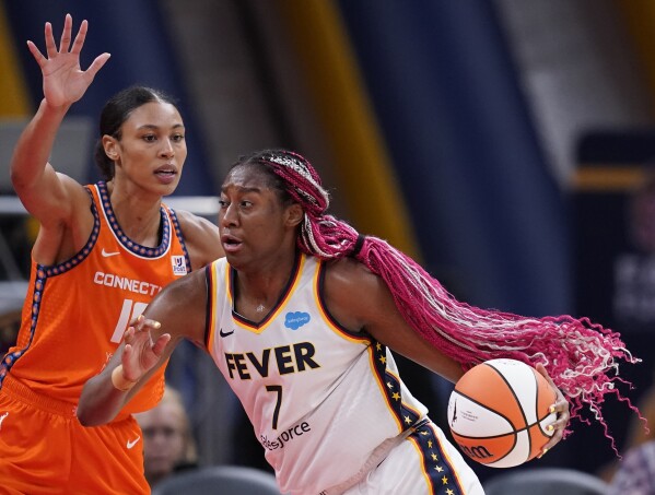 FILE - Indiana Fever's Aliyah Boston (7) is defended by Connecticut Sun's Olivia Nelson-Ododa, left, during the first half of a WNBA basketball game Aug. 4, 2023, in Indianapolis. The WNBA is using some fresh faces in its Player Marketing Agreement cohort this season. The league's past two Rookie of the Year winners, Boston and Rhyne Howard, of Atlanta, are two of the six players chosen this offseason to take part in the program. (AP Photo/Darron Cummings, File)