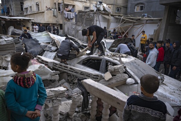 Palestinians inspect a house after it was hit by an Israeli bombardment on Rafah, southern Gaza Strip, Wednesday, Dec. 20, 2023. (AP Photo/Fatima Shbair)