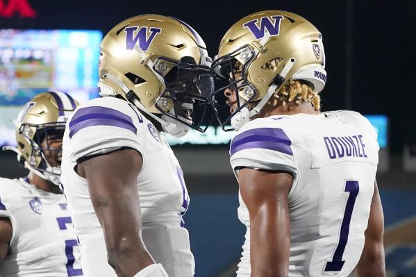 Washington wide receiver Rome Odunze (1) celebrates his touchdown catch against UCLA with quarterback Michael Penix Jr., left, during the first half of an NCAA college football game Friday, Sept. 30, 2022, in Pasadena, Calif. (AP Photo/Marcio Jose Sanchez)