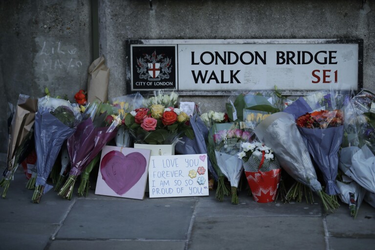 FILE - In this Monday, Dec. 2, 2019 file photo, tributes are placed by the southern end of London Bridge, three days after a man stabbed two people to death and injured three others before being shot dead by police, in London. Knife crimes are on the rise in England and Wales, and a string of deadly attacks in recent years has stoked public anxiety and led to calls for the government to do more. (AP Photo/Matt Dunham, file)