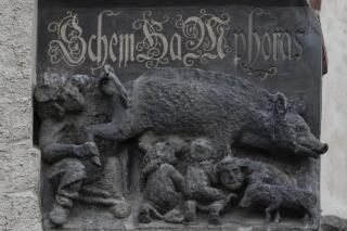 FILE - The so-called "Judensau," or "Jew pig," sculpture is displayed on the facade of the Stadtkirche (Town Church) in Wittenberg, Germany, Jan. 14, 2020. A German federal court on Monday mulled a Jewish man's bid to force the removal of the 700-year-old antisemitic statue from the church where Martin Luther once preached, say it will deliver its verdict in the long-running dispute next month. (AP Photo/Jens Meyer, File )