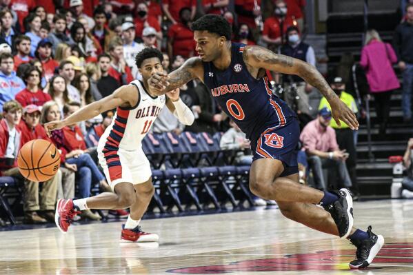 Auburn guard K.D. Johnson (0) comes up with a steal as Mississippi guard Matthew Murrell (11) looks on during the first half of an NCAA college basketball game in Oxford, Miss., Saturday, Jan. 15, 2022. (AP Photo/Bruce Newman)