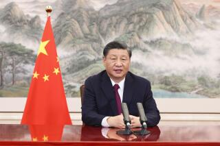 In this photo released by China's Xinhua News Agency, Chinese president Xi Jinping delivers a speech via video link to the opening ceremony of the Bo'ao Forum For Asia in Bo'ao in southern China's Hainan Province, Thursday, April 21, 2022. Xi said his government supports talks to resolve international disputes, but opposes the use of sanctions. (Huang Jingwen/Xinhua via AP)