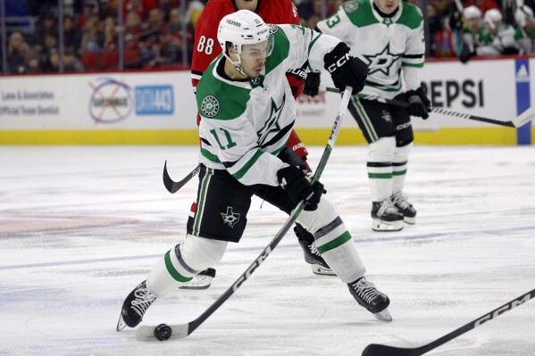 Dallas Stars' Logan Stankoven (11) shoots the puck against the Carolina Hurricanes during the first period of an NHL hockey game in Raleigh, N.C., Saturday, Feb. 24, 2024. (AP Photo/Karl B DeBlaker)