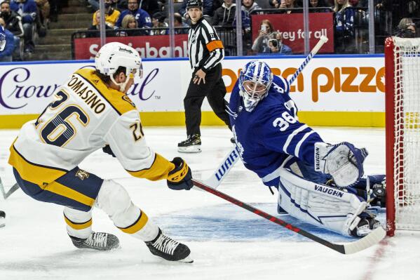 Toronto Maple Leafs goaltender Jack Campbell saves a shot by Nashville Predators' Philip Tomasino during the first period of an NHL hockey game in Toronto, Tuesday, Nov. 16, 2021. (Chris Young/The Canadian Press via AP)