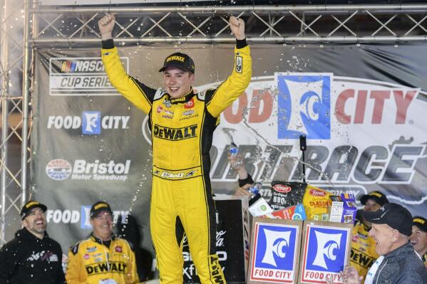 Christopher Bell celebrates after winning the NASCAR Cup Series dirt auto race, Sunday, April 9, 2023, at Bristol Motor Speedway, in Bristol, Tenn. (Emily Ball/Bristol Herald Courier via AP)