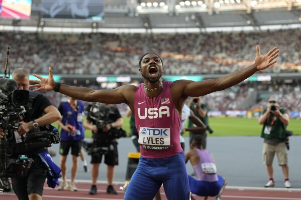 Noah Lyles, of the United States, celebrates after winning the Men's 100 meters during the World Athletics Championships in Budapest, Hungary, Sunday, Aug. 20, 2023. (AP Photo/Ashley Landis)