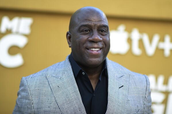 FILE - Magic Johnson arrives at the premiere of "They Call Me Magic" on Thursday, April 14, 2022, at Regency Village Theatre in Los Angeles. NFL owners unanimously approved the sale of the Washington Commanders on Thursday, July 2023, from Dan Snyder to a group led by Josh Harris and including Magic Johnson for a record $6.05 billion. (Photo by Richard Shotwell/Invision/AP, File)