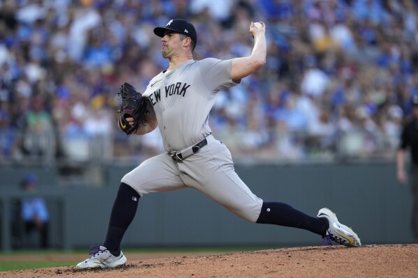 New York Yankees starting pitcher Carlos Rodón throws during the first inning of a baseball game against the Kansas City Royals Monday, June 10, 2024, in Kansas City, Mo. (AP Photo/Charlie Riedel)