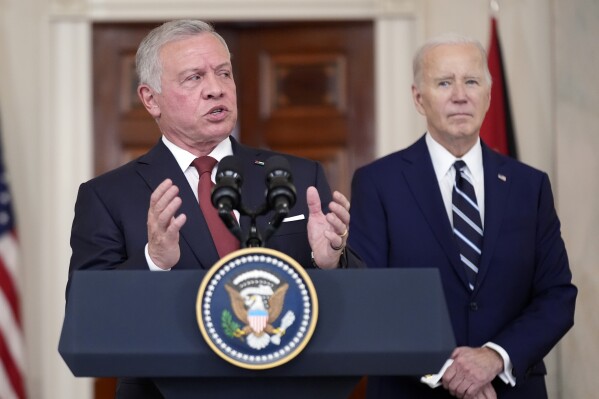 Jordan's King Abdullah II speaks as President Joe Biden listens in the Cross Hall of the White House, Monday, Feb. 12, 2024, in Washington. (AP Photo/Andrew Harnik)