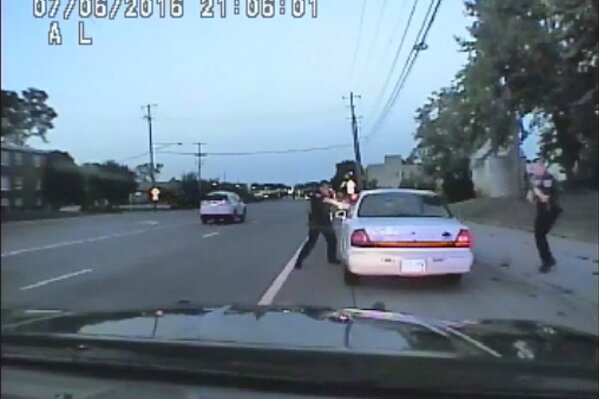 
              In this image made from July 6, 2016, video captured by a camera in the squad car of St. Anthony Police officer Jeronimo Yanez, the Minnesota police officer shoots at Philando Castile in the vehicle during a traffic stop in Falcon Heights, Minn. Yanez's backup officer Joseph Kauser is seen standing on the passenger side of the vehicle. The video was made public by the Minnesota Bureau of Criminal Apprehension and the Ramsey County Attorney's Office, Tuesday, June 20, 2017, just days after the officer was acquitted on all counts in the case. (St. Anthony Police department via AP)
            
