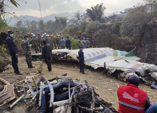 Rescuers stand by wreckage of a passenger plane that crashed in Pokhara, Nepal, Monday, Jan 16, 2023. A spokesman for Nepal’s Civil Aviation Authority says a flight data recorder and a cockpit voice recorder have been retrieved from the site of the crash of a passenger plane that went down on approach to a newly opened airport in the tourist town of Pokhara. (AP Photo/Anish Bhattarai)