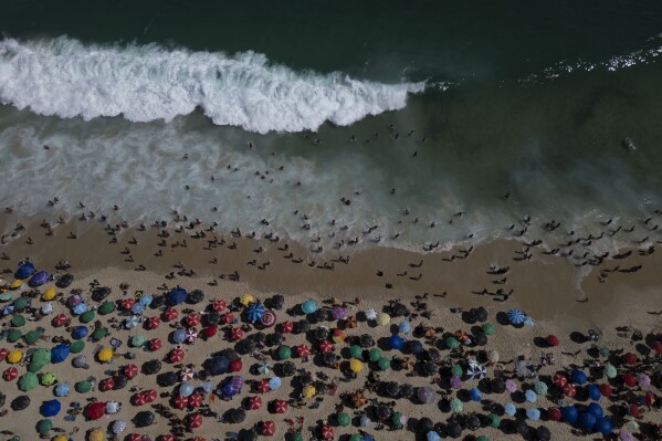 People flock to Ipanema beach during summer in Rio de Janeiro, Sunday, Feb. 16, 2025. (AP Photo/Bruna Prado)