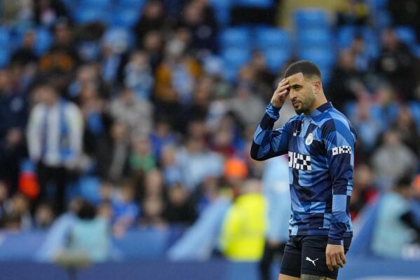 Manchester City's Kyle Walker gestures during the warm up before the English FA Cup quarter final soccer match between Manchester City and Burnley at the Etihad stadium in Manchester, England, Saturday, March 18, 2023. (AP Photo/Jon Super)
