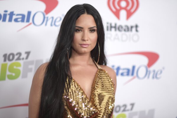 FILE - In this Dec. 1, 2017 file photo, Demi Lovato arrives at Jingle Ball at The Forum in Inglewood, Calif. Lovato will perform the National Anthem at Super Bowl. NFL and Fox on Thursday, Jan. 16, 2020 announced the performance, which will take place ahead of the big game on Feb. 2 at Hard Rock Stadium in Miami. Jennifer Lopez and Shakira will headline the halftime show. (Photo by Richard Shotwell/Invision/AP, File)