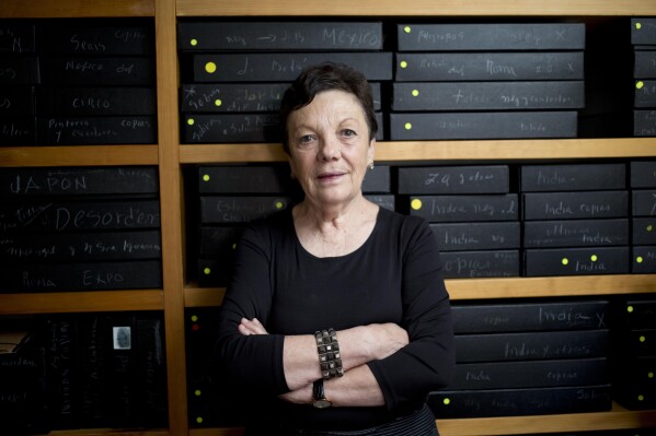 Mexican photographer Graciela Iturbide poses for a picture in front of her archived negatives during an interview with the Associated Press at her home in Mexico City, Wednesday, March 11, 2015. (AP Photo/Eduardo Verdugo, file)
