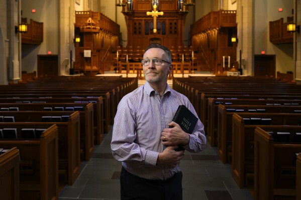 Chaplain of The Covenant School Matthew Sullivan stands in the school's church sanctuary where he lead chapel service in the past, Friday, March 22, 2024, in Nashville, Tenn. Facing the first anniversary of a tragic shooting which left six people dead, the school, which has been meeting in a temporary location, prepares to move back into the building where it happened. (AP Photo/John Amis)
