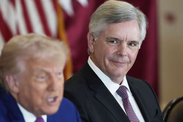 President Donald Trump speaks as Larry Culp, CEO of GE Aerospace smiles during a business roundtable, Thursday, May 15, 2025, in Doha, Qatar. (AP Photo/Alex Brandon)