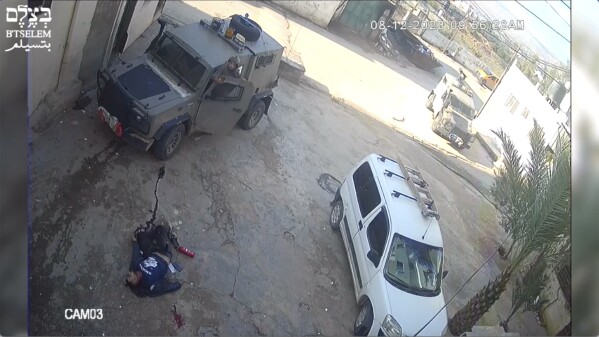 This image taken from video taken on Dec 8, 2023, in the Faraa refuge camp shows soldiers shooting down the men at close range when they did not appear to pose a threat. Security footage obtained by the Israeli human rights group B'Tselem shows two Israeli soldiers pursuing shooting the men — one while he was incapacitated and the other appearing to be unarmed — during a raid in a West Bank refugee camp. (B'Tselem via AP)