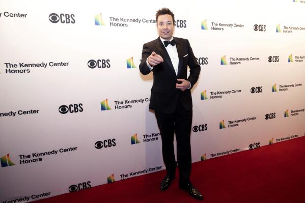 FILE - Jimmy Fallon poses on the red carpet at the honors gala for the 44th Kennedy Center Honors on Sunday, Dec. 5, 2021, in Washington. On Tuesday, Dec. 7 Fallon will release his holiday single "It Was A… (Masked Christmas)," featuring Ariana Grande and Megan Thee Stallion. (AP Photo/Kevin Wolf, File)