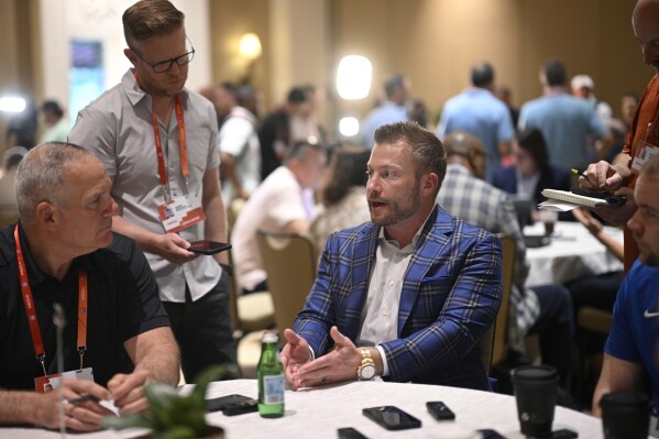 Los Angeles Rams head football coach Sean McVay, center, talks with reporters during an NFC coaches availability at the NFL owners meetings, Tuesday, March 26, 2024, in Orlando, Fla. (AP Photo/Phelan M. Ebenhack)