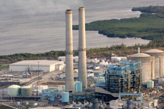 FILE- In this Feb. 26, 2009 file photo, the Turkey Point nuclear plant south of Miami is shown. Federal officials have reversed a decision to allow a South Florida nuclear power plant to continue running for another 30 years by ordering a new review of potential environmental risks, including those posed by climate change. The U.S. Nuclear Regulatory Commission issued an order Thursday, Feb. 24, 2022. (AP Photo/Lynne Sladky, File)