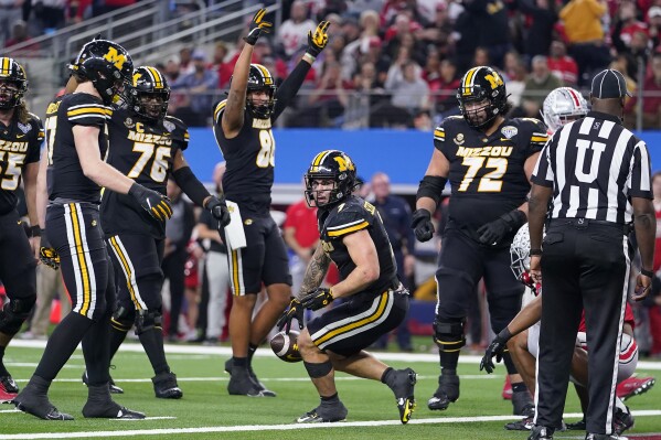 Missouri running back Cody Schrader, middle, and teammates celebrate his touchdown against Ohio State during the second half of the Cotton Bowl NCAA college football game Friday, Dec. 29, 2023, in Arlington, Texas. (AP Photo/Julio Cortez)
