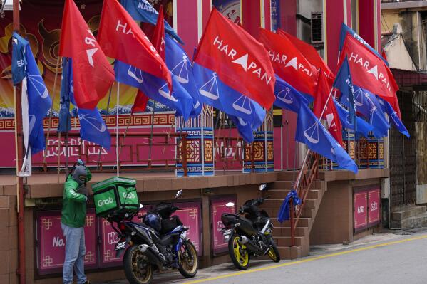 Various of party flags are seen in downtown Melacca, Malaysia, Saturday, Nov. 20, 2021. Voters wearing masks are casting their ballots in a Malaysian state election that pits Prime Minister Ismail Sabri Yaakob’s Malay party against its allies in the government for the first time amid a widening rift. (AP Photo/Vincent Thian)