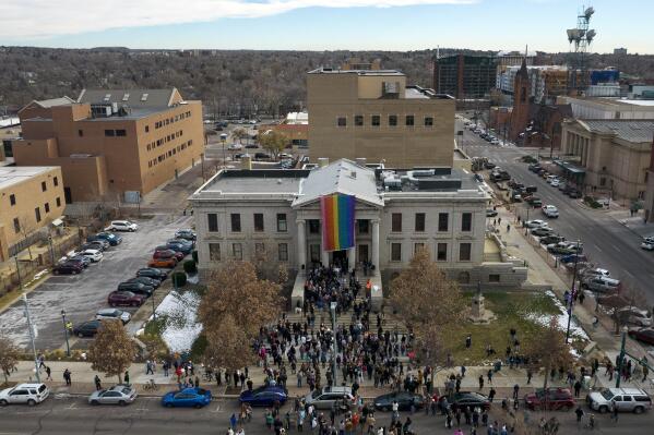In this aerial image taken with a drone, a rainbow flag is unfurled at City Hall Wednesday, Nov. 23, 2022, in Colorado Springs, Colo. With a growing and diversifying population, the city nestled at the foothills of the Rockies is a patchwork of disparate social and cultural fabrics. But last weekend鈥檚 shooting has raised uneasy questions about the lasting legacy of cultural conflicts that caught fire decades ago and gave Colorado Springs a reputation as a cauldron of religion-infused conservatism, where LGBTQ people didn't fit in with the most vocal community leaders' idea of family values (AP Photo/Brittany Peterson)