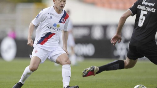 Former Japan forward Kazuyoshi Miura, left, plays for Oliveirense in the second half of a football match against Academico de Viseu in Viseu, Portugal, on April 22, 2023. Miura, who is 56, has signed a new loan deal in Portugal, the second-tier club Oliveirense posted on social media on Tuesday, July 11, 2023. (Kyodo News via AP)