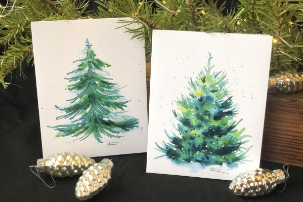 This image provided by Judy A. Steiner shows handmade watercolor Christmas tree cards. Handmade holiday cards can be gifts in themselves for both maker and receiver. They're a way to express creativity and connection. And gathering to make them can be a nice social activity. (Judy A. Steiner via AP)