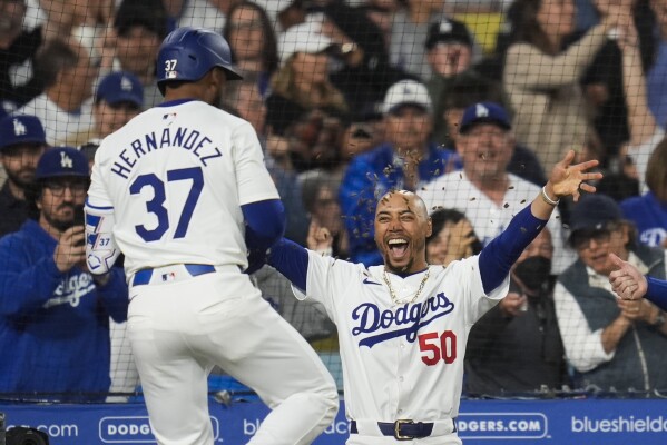 Los Angeles Dodgers' Teoscar Hernández (37) celebrates with Mookie Betts (50) after hitting a home run during the fourth inning of a baseball game against the Atlanta Braves in Los Angeles, Friday, May 3, 2024. (AP Photo/Ashley Landis)