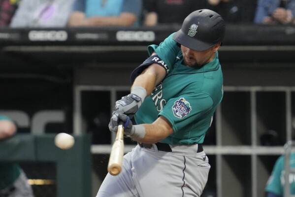 Seattle Mariners' Cal Raleigh hits a two-run double during the first inning of a baseball game against the Chicago White Sox in Chicago, Monday, Aug. 21, 2023. (AP Photo/Nam Y. Huh)