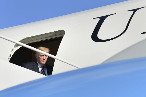 
              President Donald Trump steps through the door of Air Force One at Morristown Municipal Airport in Morristown, N.J., Friday, Sept. 29, 2017. Trump is spending the weekend in Bedminster, N.J., at his golf club. (AP Photo/Susan Walsh)
            