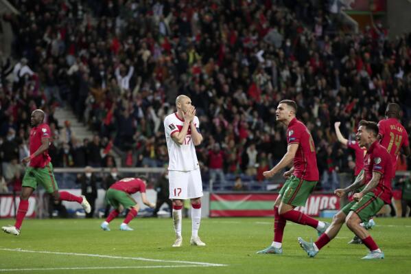Turkey's Burak Yilmaz, center, reacts after missing a penalty shot during the World Cup 2022 playoff soccer match between Portugal and Turkey, at the Dragao stadium in Porto, Portugal, Thursday, March 24, 2022. (AP Photo/Luis Vieira)