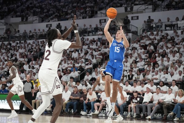 Kentucky guard Reed Sheppard (15) shoots over Mississippi State forward KeShawn Murphy (12) during the second half of an NCAA college basketball game Tuesday, Feb. 27, 2024, in Starkville, Miss. (AP Photo/Rogelio V. Solis)