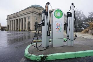 FILE - An electric car charging station is positioned outside the Science Museum where Virginia State Senators are meeting for their 2021 legislative session in Richmond, Va., Feb. 18, 2021. Virginia is currently on a path toward adopting California’s new, stringent rules for transitioning to zero-emission vehicles because of 2021 legislation that involved adopting the West Coast state’s emissions standards. That's according to attorneys and state officials who weighed in after California regulators adopted the new rules Thursday, Aug. 25, 2022. (AP Photo/Steve Helber, File)