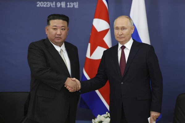 FILE - Russian President Vladimir Putin, right, and North Korean leader Kim Jong Un shake hands during their meeting at the Vostochny cosmodrome outside the city of Tsiolkovsky, about 200 kilometers (125 miles) from the city of Blagoveshchensk in the far eastern Amur region, Russia on Sept. 13, 2023. North Korean leader Kim hailed the country's relationship with Russia on Wednesday, June 12, 2024, as reports suggest that Russian President Putin will soon visit the isolated country for his third meeting with Kim.(Vladimir Smirnov/Sputnik Kremlin Pool Photo via AP, File)