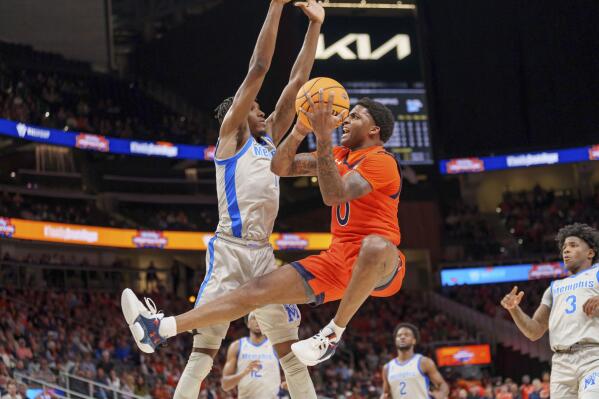 Auburn guard K.D. Johnson (0) goes to the basket as Memphis' Keonte Kennedy defends during the first half of an NCAA college basketball game Saturday, Dec. 10, 2022, in Atlanta. (AP Photo/Erik Rank)