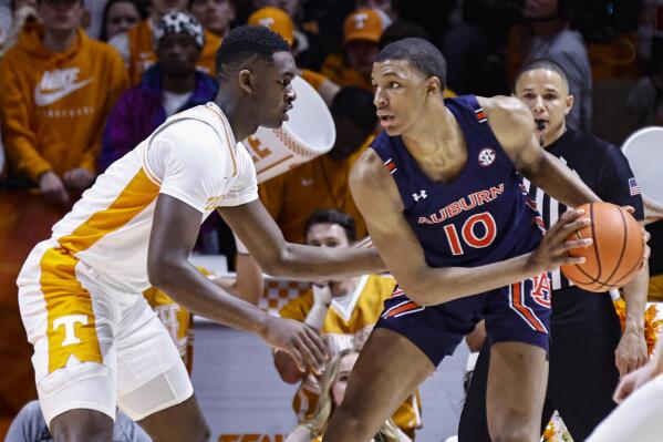 Auburn forward Jabari Smith (10) works for a shot as he is defended by Auburn guard K.D. Johnson (0) during the first half of an NCAA college basketball game Saturday, Feb. 26, 2022, in Knoxville, Tenn. (AP Photo/Wade Payne)