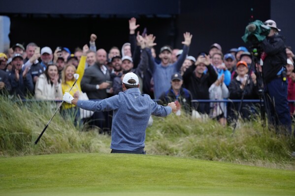 United States' Scottie Scheffler reacts to the crowd aft a bride shot from a bunker on the 18th green during the second day of the British Open Golf Championships at the Royal Liverpool Golf Club in Hoylake, England, Friday, July 21, 2023. (AP Photo/Jon Super)