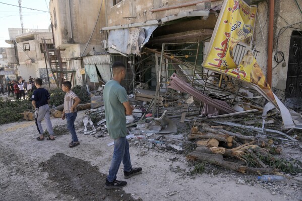 Palestinians inspect the damage in Al Fara'a refugee camp in the occupied West Bank following an Israeli military raid, Monday, June 10, 2024. Israel's military killed a 15-year-old Palestinian in an overnight raid on Al Fara'a refugee camp in the occupied West Bank, according to Palestinian health officials. The military said Monday that it had begun what it described as a 