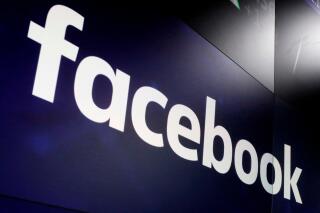 FILE - In this March 29, 2018, file photo, the logo for Facebook appears on screens at the Nasdaq MarketSite in New York's Times Square. Facebook has apologized for putting a “primates" label on a video of Black men, in June 2021, according to a report in the New York Times. (AP Photo/Richard Drew, File)