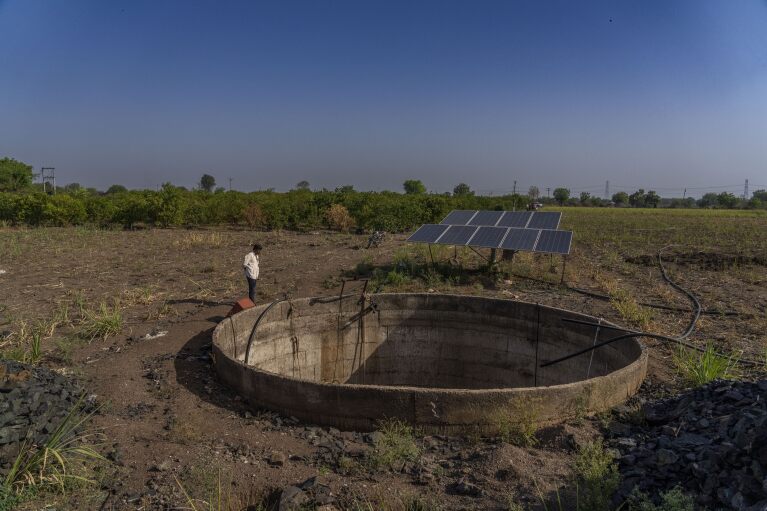 Lahuane Rao, an elected head of a village, gazes into the dry well near damaged sugarcane fields due to drought in Beed district, India, Saturday, May 4, 2024. Experts suggest growing crops that need less water. (AP Photo/Rafiq Maqbool)