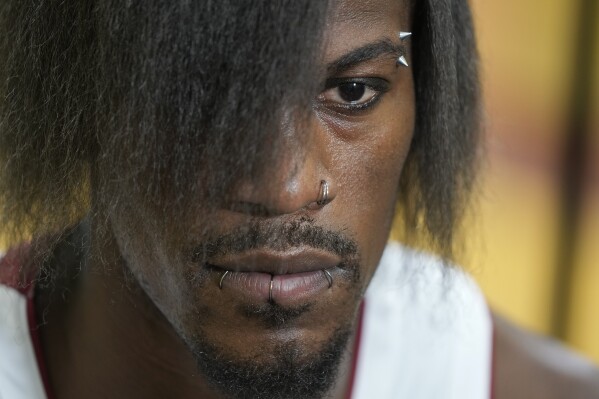 Miami Heat forward Jimmy Butler, sporting a new hairdo and piercings, answers questions during an interview as part of the NBA basketball team's media day, in Miami, Monday, Oct. 2, 2023. (AP Photo/Rebecca Blackwell)