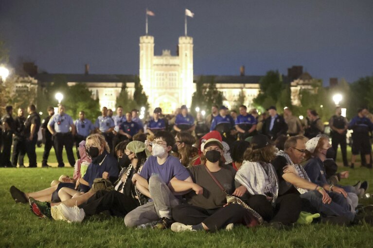 Protesters in support of Palestinians link arms as police prepare to arrest them on Washington University's campus in St. Louis, Saturday, April 27, 2024. (Christine Tannous/St. Louis Post-Dispatch via AP)