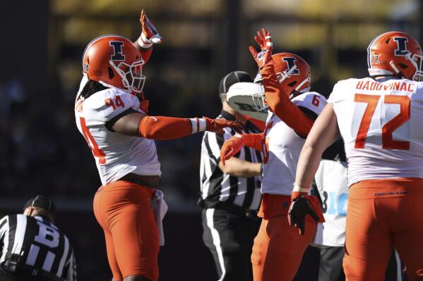 Illinois defensive lineman Jer'Zhan Newton (94) and teammate defensive back Tony Adams (6) celebrate during the second half of an NCAA college football game against Minnesota on Saturday, Nov. 6, 2021, in Minneapolis. Illinois won 14-6. (AP Photo/Stacy Bengs)