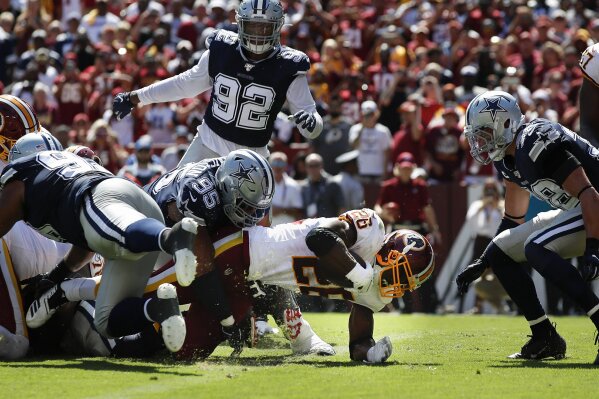 Washington Redskins running back Adrian Peterson (26) scores a touchdown against the Dallas Cowboys in the first half of an NFL football game, Sunday, Sept. 15, 2019, in Landover, Md. (AP Photo/Alex Brandon)